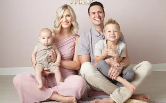 Mompreneur Cristina Gamarnik sitting next to her husband with their two kids in their laps